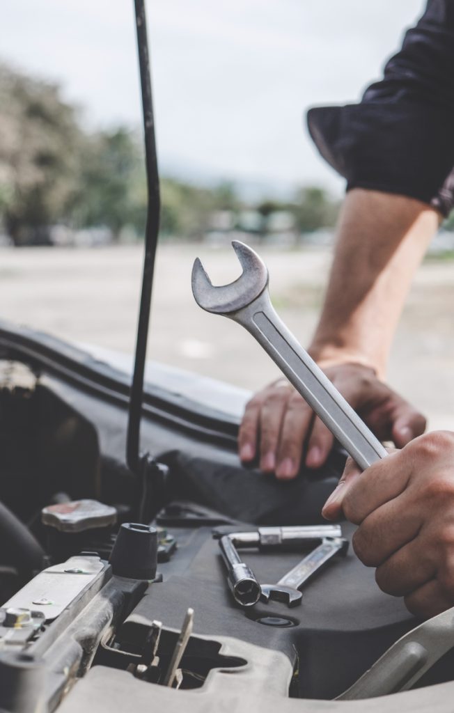 Mechanic holding a spanner - Car Repairs in Littlehampton, Worthing and Bognor